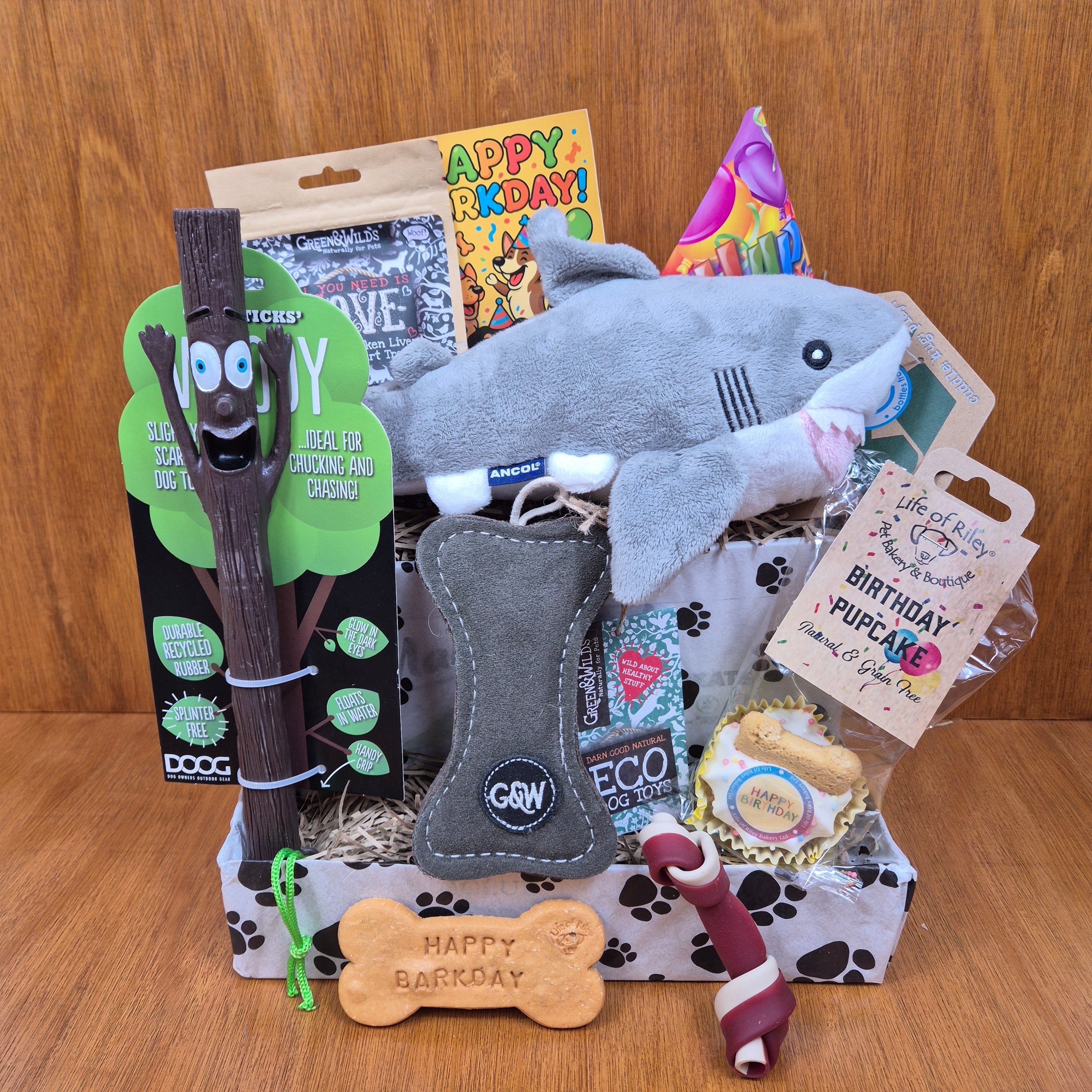 a jammed packed birthday box for small dogs filled with premium treats and toys