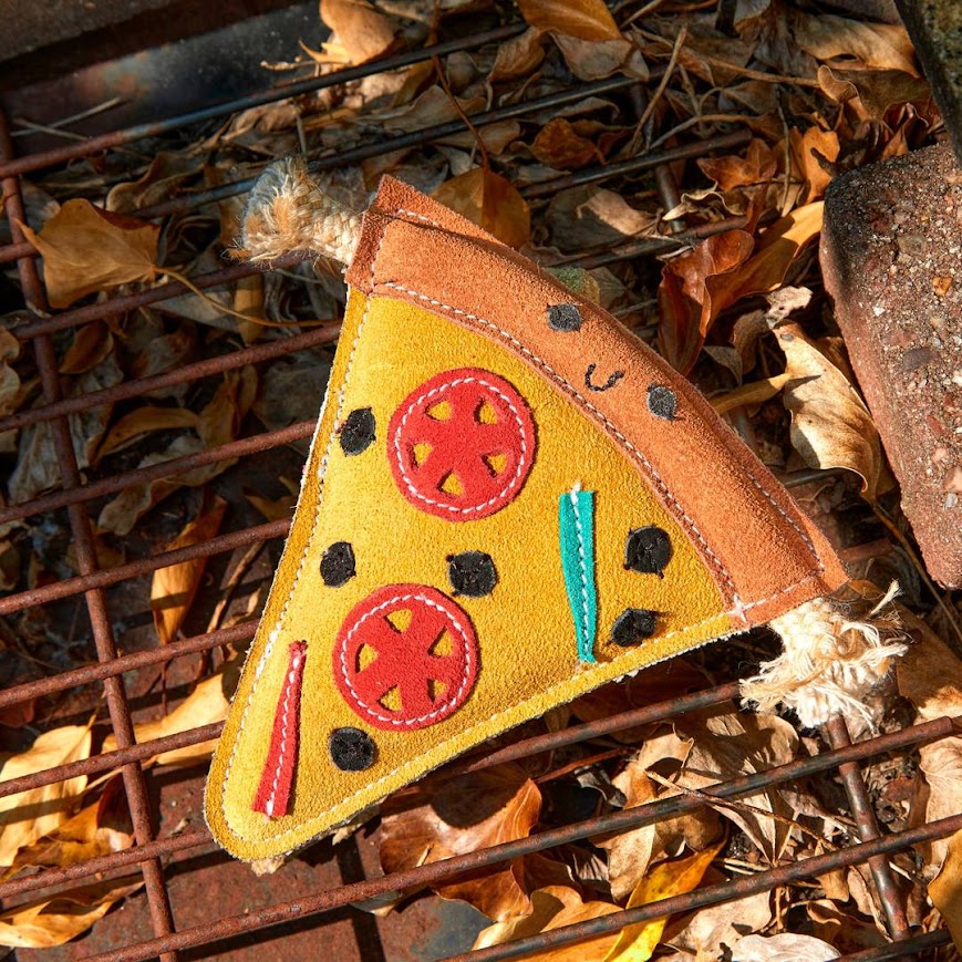 Eco friendly Pepe le Pizza dog toy by Green and Wild’s photographed oudoors on a pizza making grill, supplied by Paw Branch
