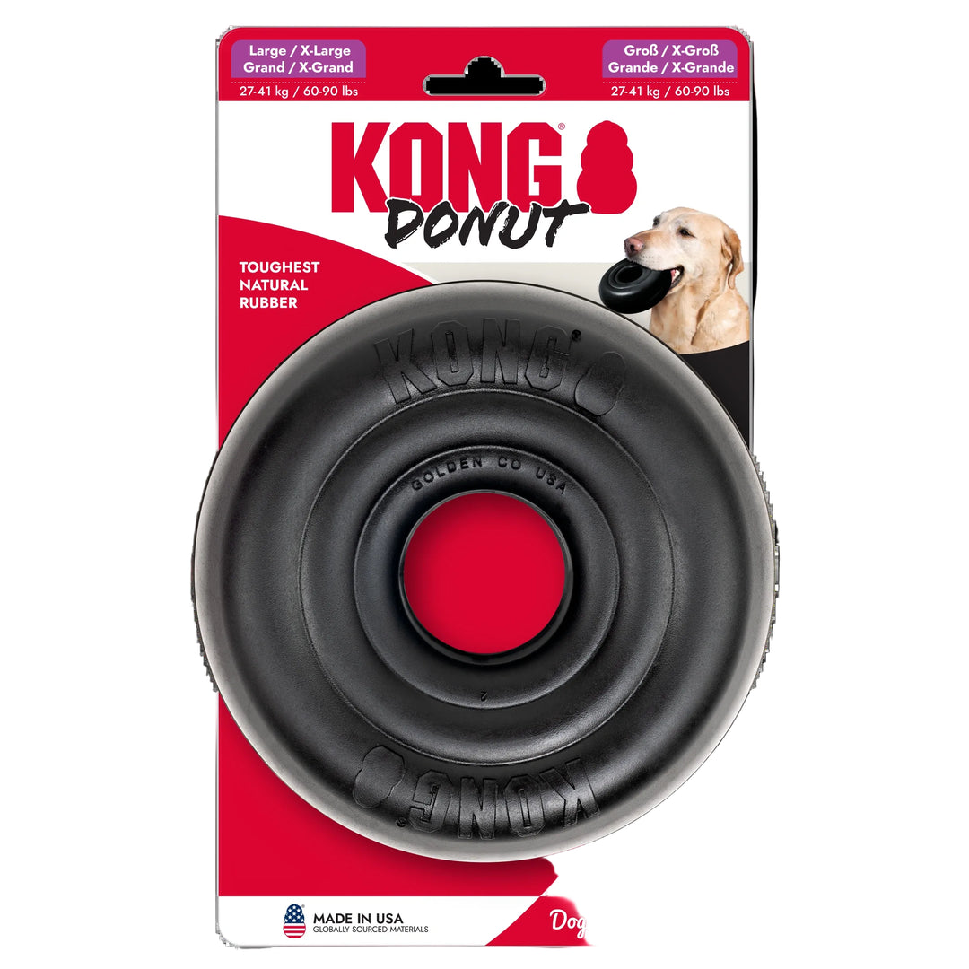 Kong Donut dog toy in its original retail packaging, featuring a black rubber donut-shaped toy with a red center, branded with 'KONG Donut' on the card.