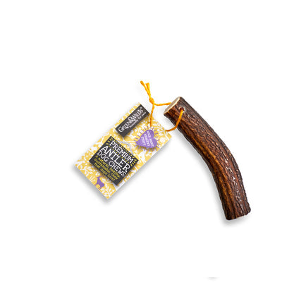 Dog antler medium sized chew with packaging on a white background