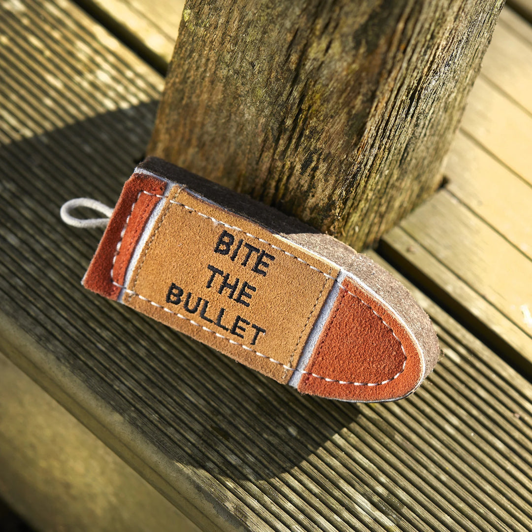 Bullet shaped eco friendly dog toy made from compressed wool felt and suede. Designed for extra small and small breeds to chew, carry and play safely.