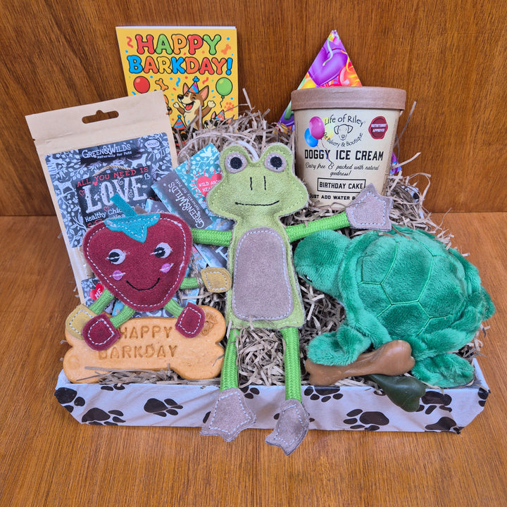 Open the Top Dog Birthday Box to reveal a mix of fun toys and wholesome treats for extra small dogs.